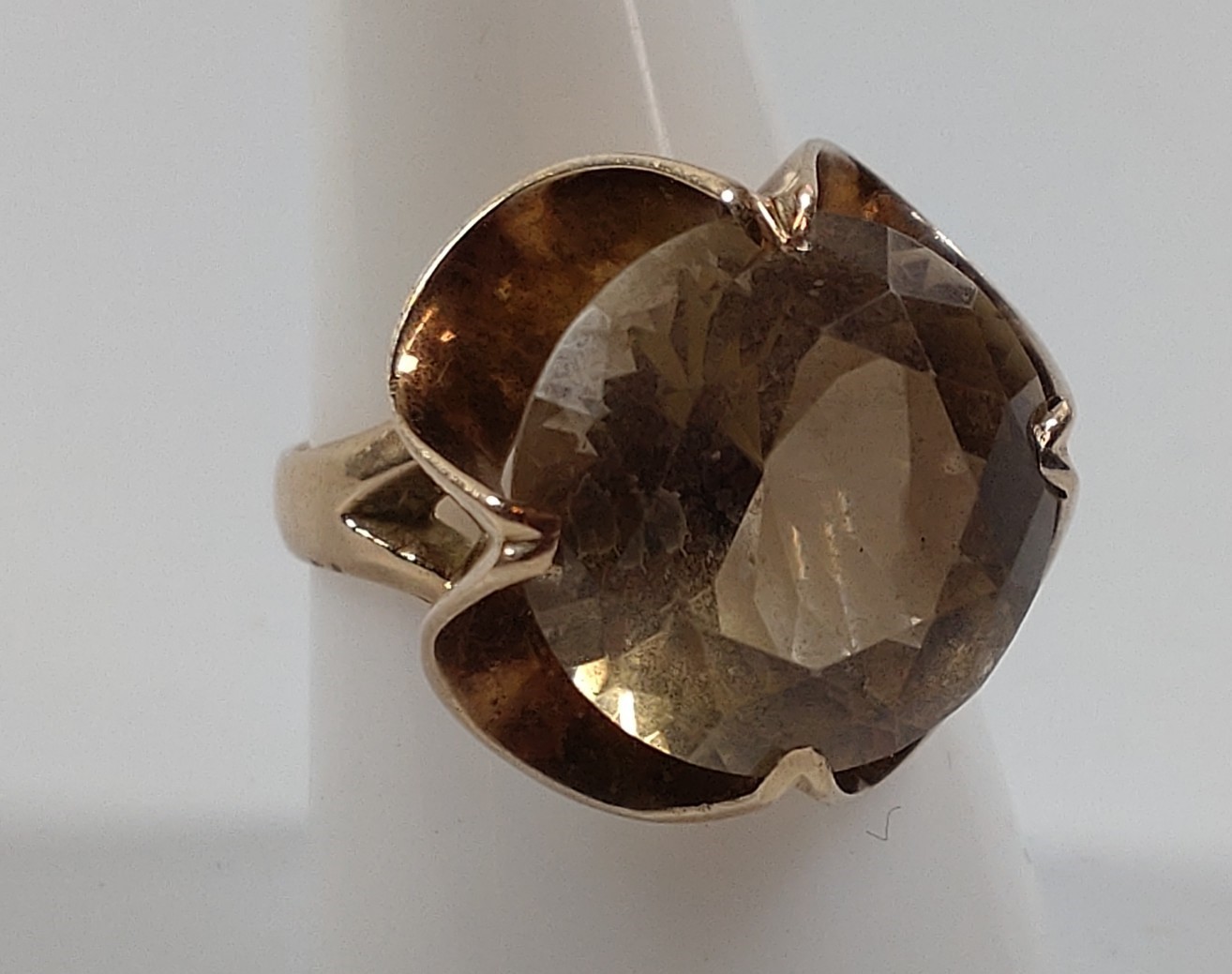 A gold colour metal ring set set with a light colour quartz. Size R. Provenance 80 Rose Street.