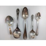 A collection of six various silver and plated spoons including caddy spoon, rifle prize spoon.