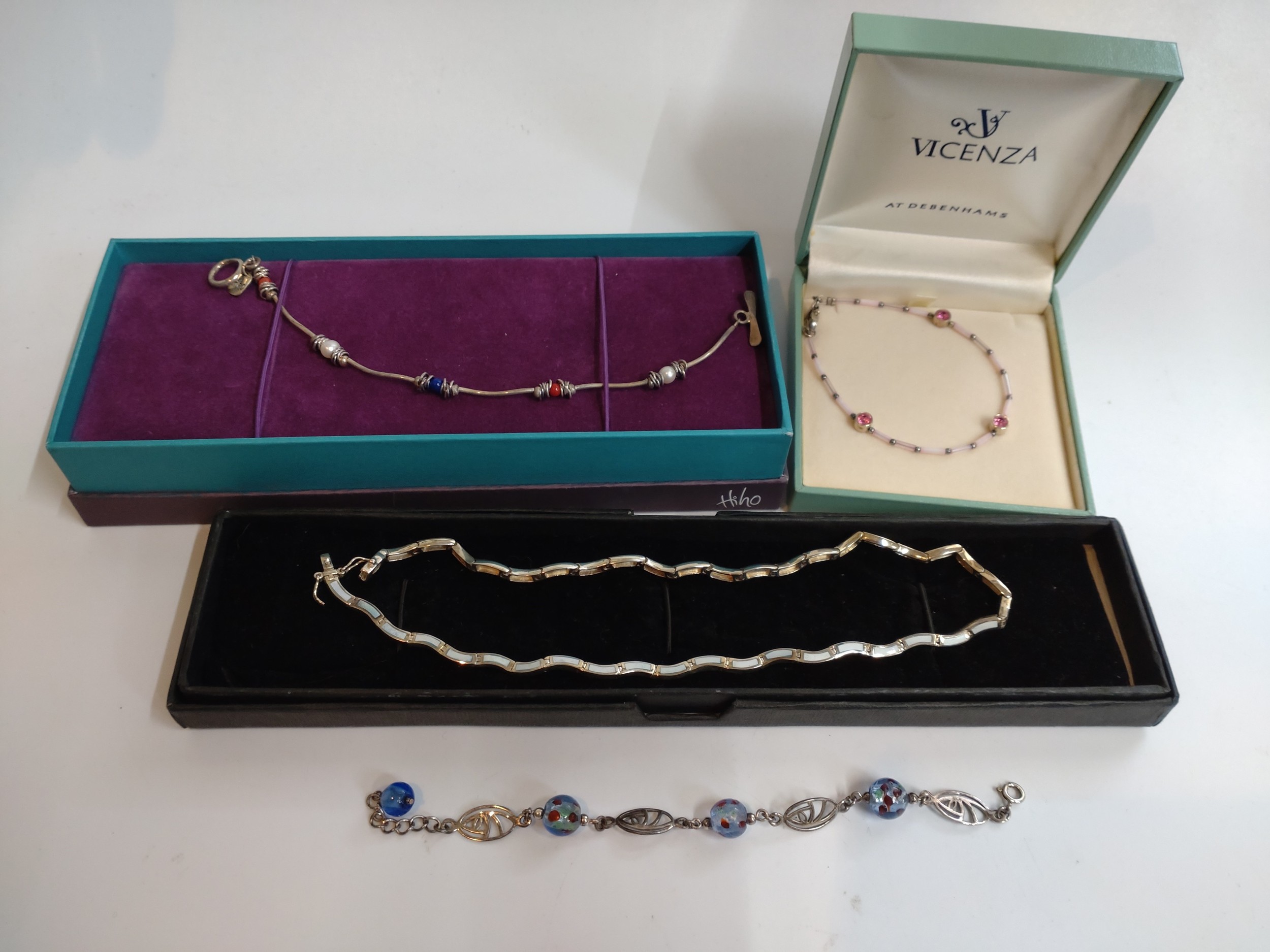 Silver necklace with inset stone design together with three small silver bracelets set with boxes.