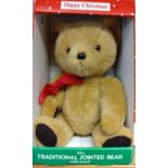 A boxed BHS Happy Christmas teddy bear. Fully jointed, with bark brown felt pads, a fully-working