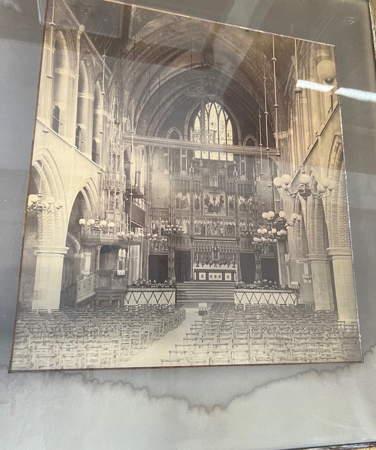 Sepia photographic print of a cathedral interior. Water damaged.