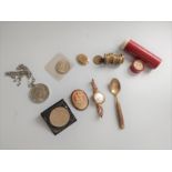 A tube of old threepenny coins, two USA coins and a Midland bank crown, and a cameo, a lady's
