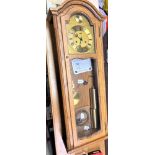 A Good Oak Cased Chiming Wall Clock. Circa 1970. Complete with grid iron pendulum, two brass weights