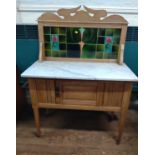 An Art Nouveau washstand, with white marble top. Circa 1900. Damage to rear right leg.