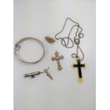 A silver bangle and a collection of crosses