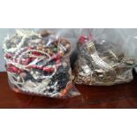 Seven large bags of costume jewellery including brooches, earrings, beads, etc.