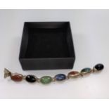 A silver bracelet set with seven oval shaped various coloured agate stones with box.