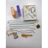 A collection of fashion jewellery including two bangles, gold chains, necklaces, etc.