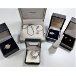 A collection of four silver rings, necklace with pendant drop and earrings.
