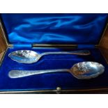 A cased pair of silver- plated fruit spoons