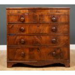A Victorian mahogany bow fronted chest of two short over three long drawers, the frieze top with