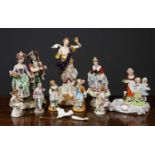 A group of ceramic figurines comprising a Derby style angel, 30cm high; a Royal Vienna figurine of a