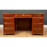 A Brights of Nettlebed modern Asian hardwood pedestal desk, with nine drawers about the knee, the