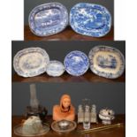 Four blue and white willow pattern style pottery platters, the largest 45cm long together with a set