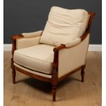 A Wesley-Burrell mahogany framed armchair, with cream upholstery within classical style carved