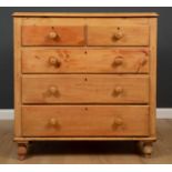 A stripped pine chest of two short and three long drawers with turned knob handles and turned