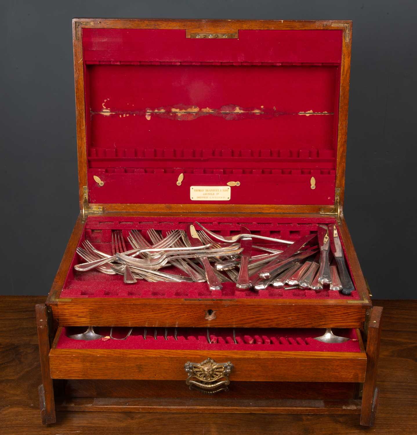 A part canteen of silver plated cutlery by Thomas Bradbury, the oak box 47cm x 34cmCondition report: