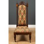 A Victorian rosewood framed prie dieu low chair, with tapestry upholstered seat, barley twist back