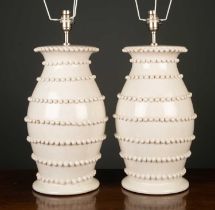 A pair of white glazed pottery lamps of baluster form with applied decoration, each 46cm high