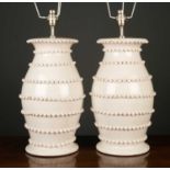 A pair of white glazed pottery lamps of baluster form with applied decoration, each 46cm high