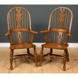 A pair of modern oak Windsor armchairs with spindle backs, on turned supports, 53cm wide x 48cm deep