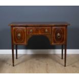 A George III mahogany and stainwood inlaid bow fronted sideboard with brass lions ring handles and