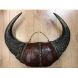 Mounted buffalo horns from Cameroon bound in the centre with leather and reeds 49cm wideCondition