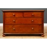 A Victorian mahogany chest of two short and two long drawers with turned knob handles and raised
