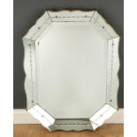 A Venetian style wall mirror with a shaped edge and bevelled glass, 62cm wide x 85cm highCondition