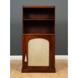 A Regency mahogany bookcase cabinet with a galleried top and fixed shelf above a brass mesh door,