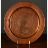 An early English turned walnut plate marked SR to the reverse, 21.5cm diameterCondition report: