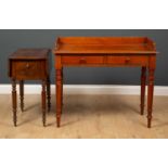 A Victorian walnut side table with a galleried back and two drawers and turned legs, 99cm wide x