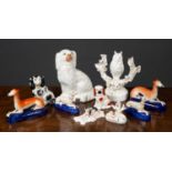 A collection of decorative ceramic dogs to include two pairs of Greyhounds formed as pen holders,