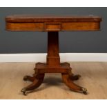 A Regency style rosewood fold over card table with beaded decoration on central square pillar and
