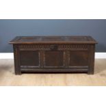 A 18th century oak coffer with a triple panelled front, 128cm wide x 55cm deep x 51cm