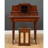 An Edwardian mahogany writing desk with a raised back, having two short drawers and a glazed