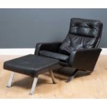 A Robin Day Leo black leatherette low armchair and footstool, with button back upholstery on bent