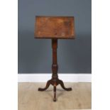 A George III mahogany reading table with a turned stem and tripod base, 45cm wide x 30cm deep x 74.