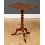 A 19th century mahogany occasional table with a bobbin turned stem, a tripod base, a rectangular