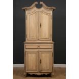 An antique oak dresser, the break scroll pediment over a pair of doors above drawer and further pair