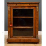 A 19th century walnut pier cabinet with a single glazed door, two fixed shelves, satinwood inlay,