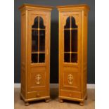 A pair of gilt painted Empire style glazed cabinets with glazed door over fitted shelves and drawer,