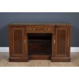 An Edwardian mahogany and satinwood inlaid breakfront desk with a green leather inset top, 123cm