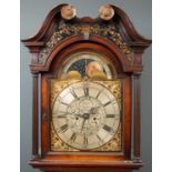 A George III mahogany eight day longcase clock with a breakarch pediment above a brass and