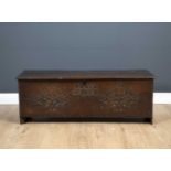 A 17th century oak six plank coffer with later carved decoration, 118cm wide x 38cm deep x 42.5cm