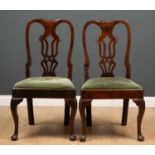 A pair of George II walnut side chairs with pierced splat backs, upholstered inset seats, cabriole