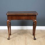 A George II mahogany fold over tea table with a concertina action cabriole legs and pad feet, 80.5cm