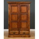 An Indian hardwood cupboard, the pair of doors over two short drawers on a plinth base, with iron