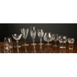 A group of glassware to include a set of eight cut glass brandy glasses, eleven cut glass wine