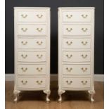 A pair of white painted bow front chests of six drawers with cabriole legs, 49cm wide x 32cm deep